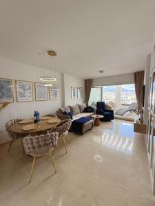 a living room with a table and a couch at PlayaDuquesa Apartment SEAVIEW in Manilva