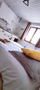 a large bed in a room with a window at Studio confort montagne in Aulus-les-Bains