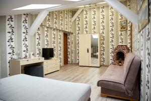 a bedroom with a fireplace and a bed and a chair at Hotel Plazma in Lviv