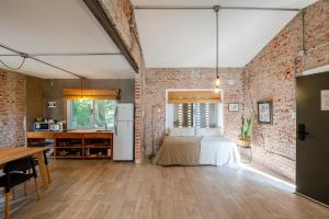 a bedroom with a bed and a brick wall at Casas Urbanas Apart Hotel in Jesús María