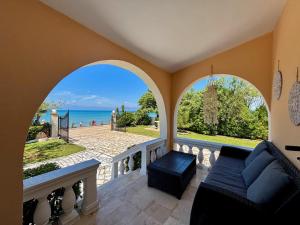 a living room with a couch and a view of the ocean at Villa Antonia- Acharavi beach in Acharavi
