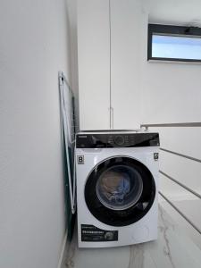 a washing machine in a corner of a room at Villa Sara in Golem