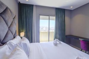 a bedroom with a large bed and a window at W-Aldorf in Casablanca