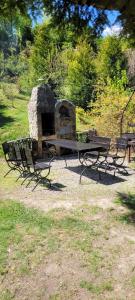 a picnic table with a stone oven in a park at Pod Magnolią in Targanice