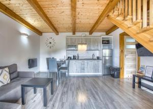 a living room with a couch and a kitchen at Domki Pokoje Fil in Solina +65 photos