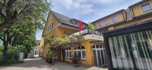 een geel gebouw met een vlag erop bij Stadthotel Kramer in Villach