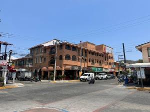 a city street with cars and buildings on a street at HUX Express-Huatulco in Santa Cruz Huatulco