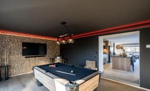a room with a pool table and a living room at Au bout du bois in Jalhay +16 photos
