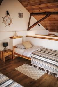 a bedroom with two beds in a attic at Agroturystyka Widokówka Nielisz in Nielisz