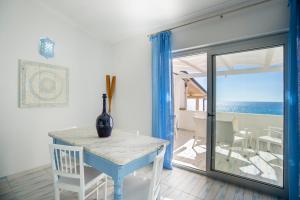 a dining room with a table and a view of the ocean at I Gradini sul Mare in Santa Maria
