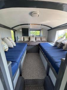 a view of the inside of an rv with couches at The Bus On The Hill in Huntsham
