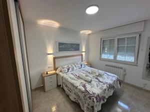 A bed or beds in a room at Apartamento Xoel