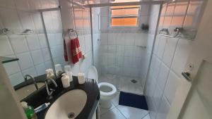a small bathroom with a sink and a toilet at casa do Pedro in Guarujá +17 photos