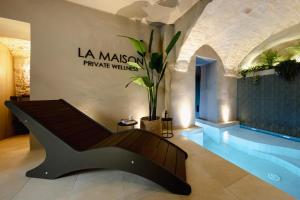a bench in a room with a sign on the wall at La Maison - Private wellness -Suite in Ostuni