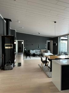a living room with a table and a couch at Huvilarannalla in Sotkamo +26 photos