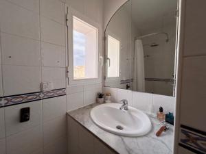 a white bathroom with a sink and a mirror at Casa Barman Casco Antiguo Y Vistas Al Mar in Altea +26 photos