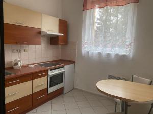 a small kitchen with a table and a window at Apartmány Sluníčko in Nová Bystřice