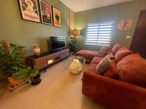 a living room with a couch and a flat screen tv at ‘Aja’ on Etna Street in Mellieħa