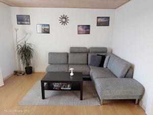 a living room with a couch and a coffee table at Venos rooms in Hirtshals