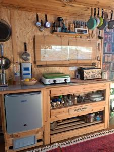 a kitchen with a wooden counter top with pots and pans at Wooden House at the Mountain-private in Paránimfoi