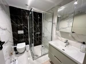 a bathroom with a shower and a toilet and a sink at Green Park Villa in Kemer
