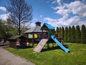 a playground with a slide and a gazebo at Apartaments Gory in Niedzica Zamek