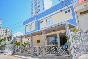 a blue and white building with a balcony at Hotel Bahía Azul Manga Cartagena in Cartagena de Indias