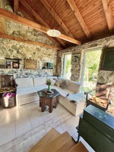 a living room with a couch and a table at Guest House Queen in Konjic