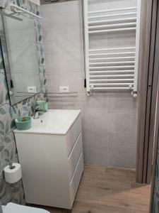 a bathroom with a white sink and a mirror at Mare&Relax in Mazara del Vallo +73 photos