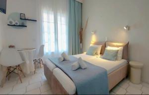 a bedroom with a bed with two pillows on it at Philippos Apartments in Acharavi
