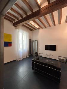 a living room with a couch and a flat screen tv at Domus in Modena