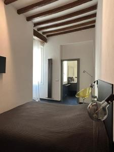 a bedroom with a bed and a window and a chair at Domus in Modena