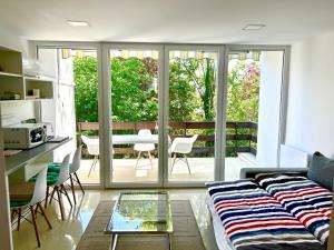 a living room with a couch and a table at MRM Apartman Tihany in Tihany