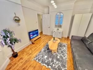 a living room with a couch and a tv at Capstone Escape in Bournemouth
