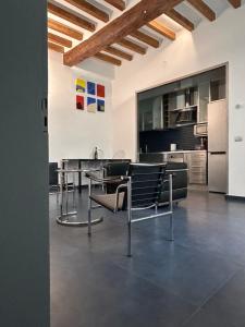 a kitchen with tables and chairs in a room at Domus in Modena