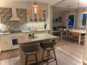 a kitchen and dining room with a table and chairs at Villa in J O K K M O K K in Jokkmokk