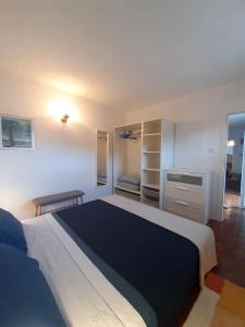 a bedroom with a large bed and a desk at Apartment ZenPunta in Pučišća