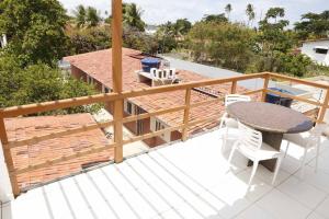 a patio with a table and chairs on a balcony at Tamandaré Residence Beach 3 in Tamandaré