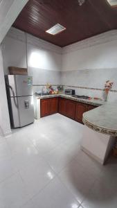 a kitchen with a refrigerator and a counter top at Casa Villetana in Villeta