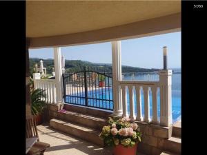 a balcony with stairs and a view of the water at Apartmani Sunce Anja in Dobra Voda