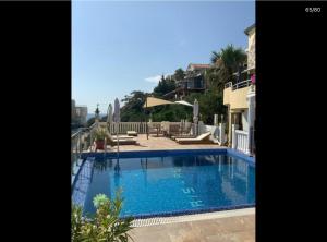 a large swimming pool in the middle of a house at Apartmani Sunce Anja in Dobra Voda