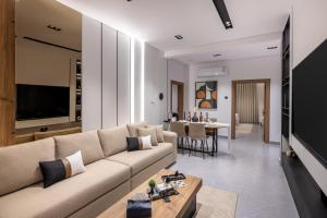 a living room with a couch and a table at Delmar Luxury 3BR Apartment 4 in Jeddah