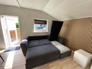 a small room with a bed and a window at Billund Sol Center House in Billund
