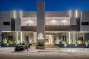 a car parked in front of a building at night at Delmar Luxury 3BR Apartment 4 in Jeddah