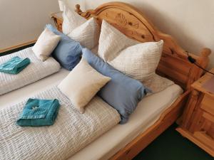 a bed with pillows on top of it at Ferienwohnung Irene in Strackholt in Großefehn  +31 photos