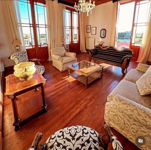a living room with a couch and a table at Casa Crespo Hotel Boutique in Patagones +2 photos