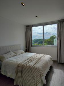 a bedroom with a bed and a large window at Depto 2 Dorm en Posadas - Lomas de Alem in Posadas +46 photos