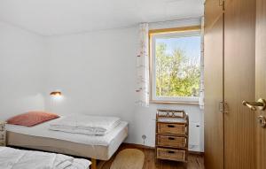a small bedroom with two beds and a window at 3 Bedroom Beautiful Home In Hesselager in Hesselager