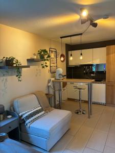 a living room with a couch and a kitchen at Cozy studio apartment in Kornwestheim