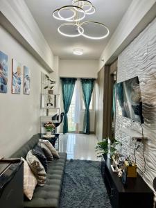 a living room with a couch and a chandelier at Jessa Rios Coast Staycation in Manila